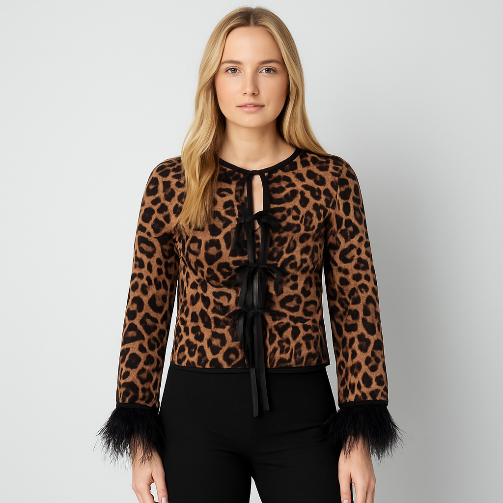 Leopard print top with bow tie closures and feather-trim sleeves.