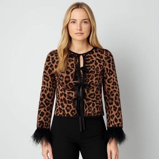 Leopard print top with bow tie closures and feather-trim sleeves.