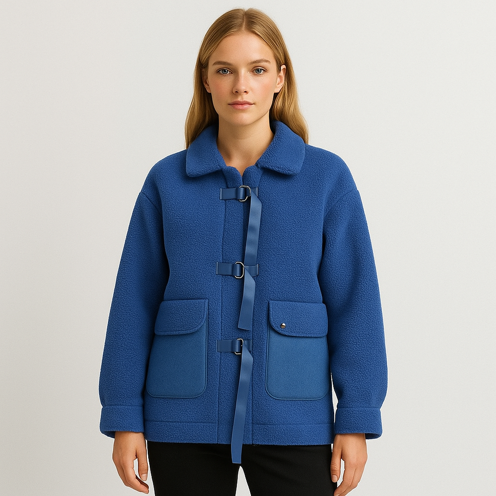 Blue fleece jacket with buckle closures, denim patch pockets, and a collared neckline.