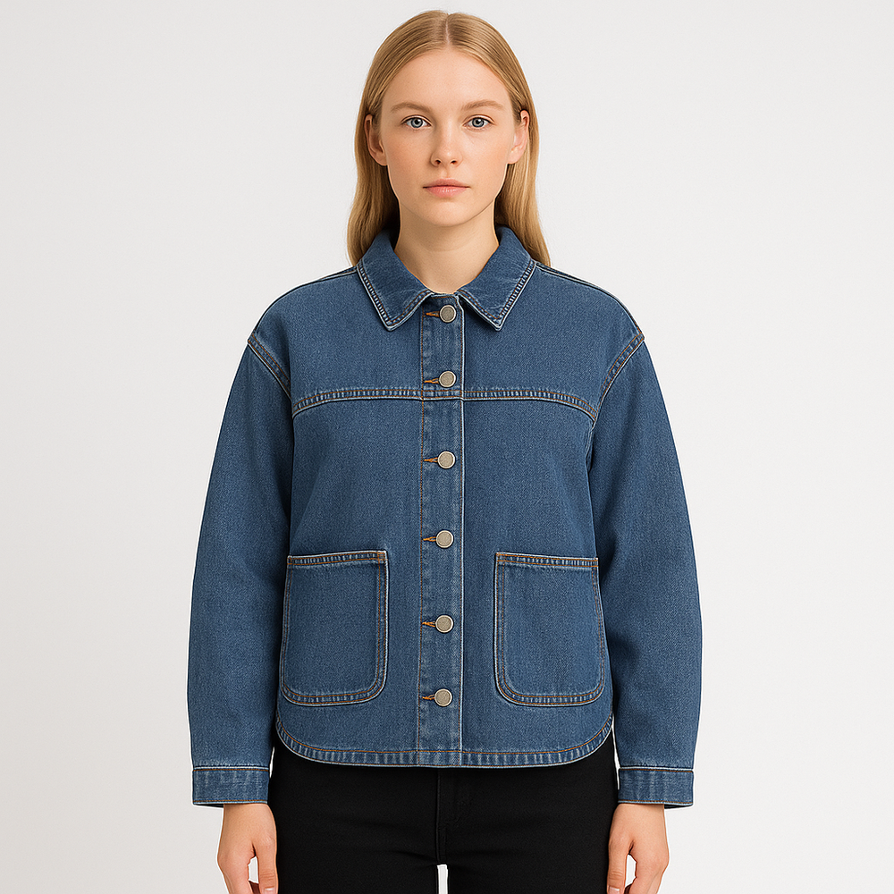 Blue denim jacket with snap-button closure, pointed collar, front patch pockets, and logo detail on the sleeve, displayed on a white background.