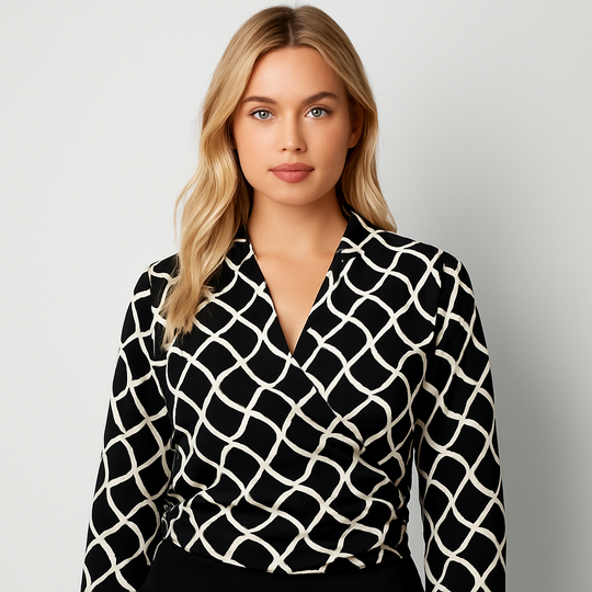 Black and white wrap blouse with geometric pattern, long sleeves, and cropped cut.